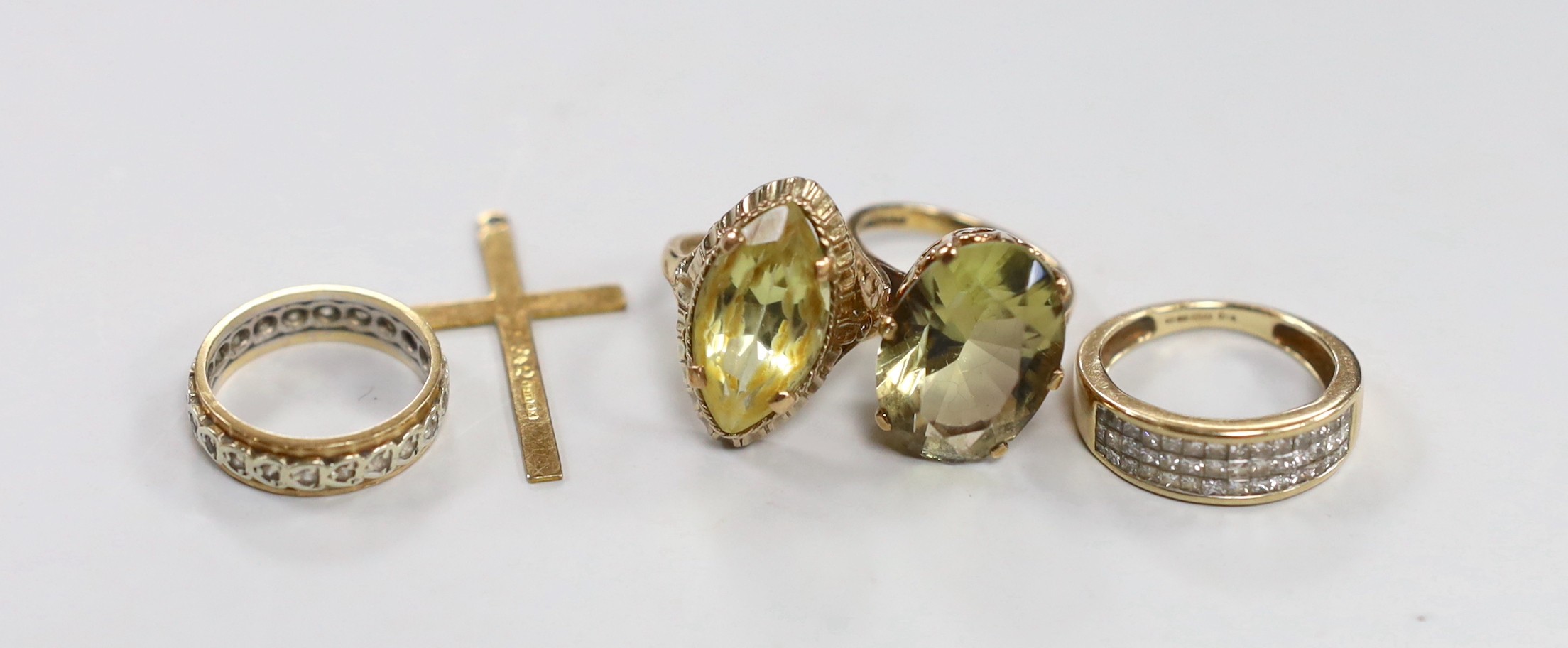 Three 9ct gold and gem set rings, gross 13.4 grams, a 9ct gold cross and one other yellow metal ring.